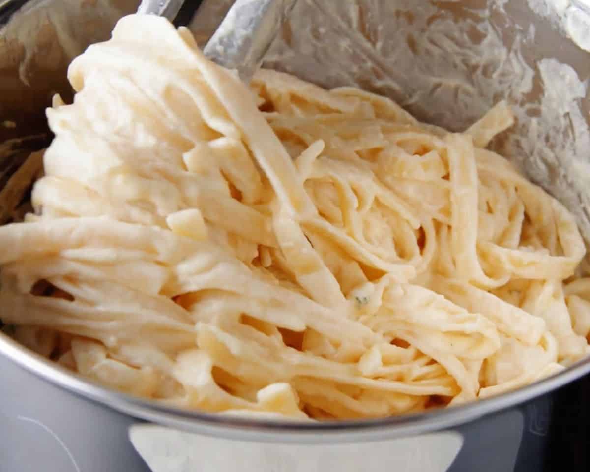 fettucine alfredo cooking in a pan
