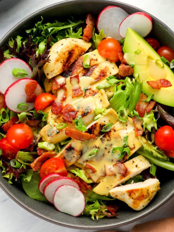 close up view of honey mustard chicken salad in a bowl.