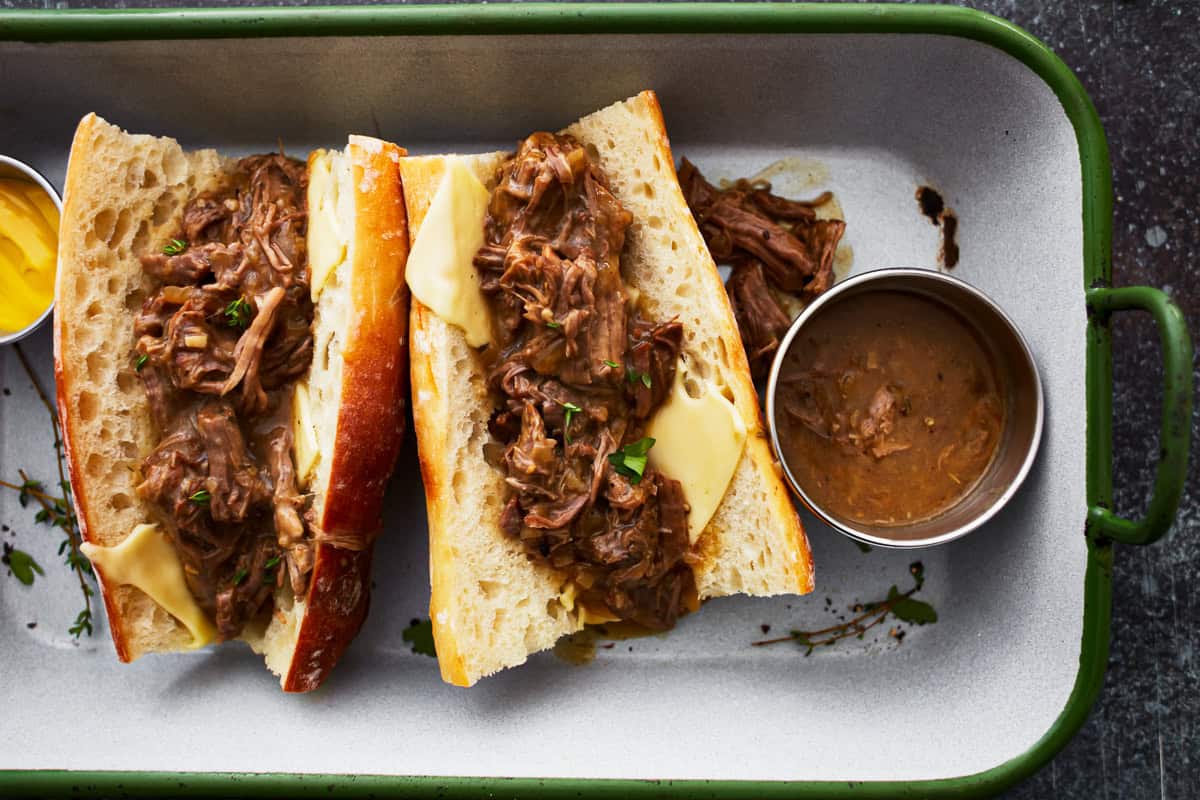 overhead view of 2 hot beef sandwiches on split rolls with cheese.