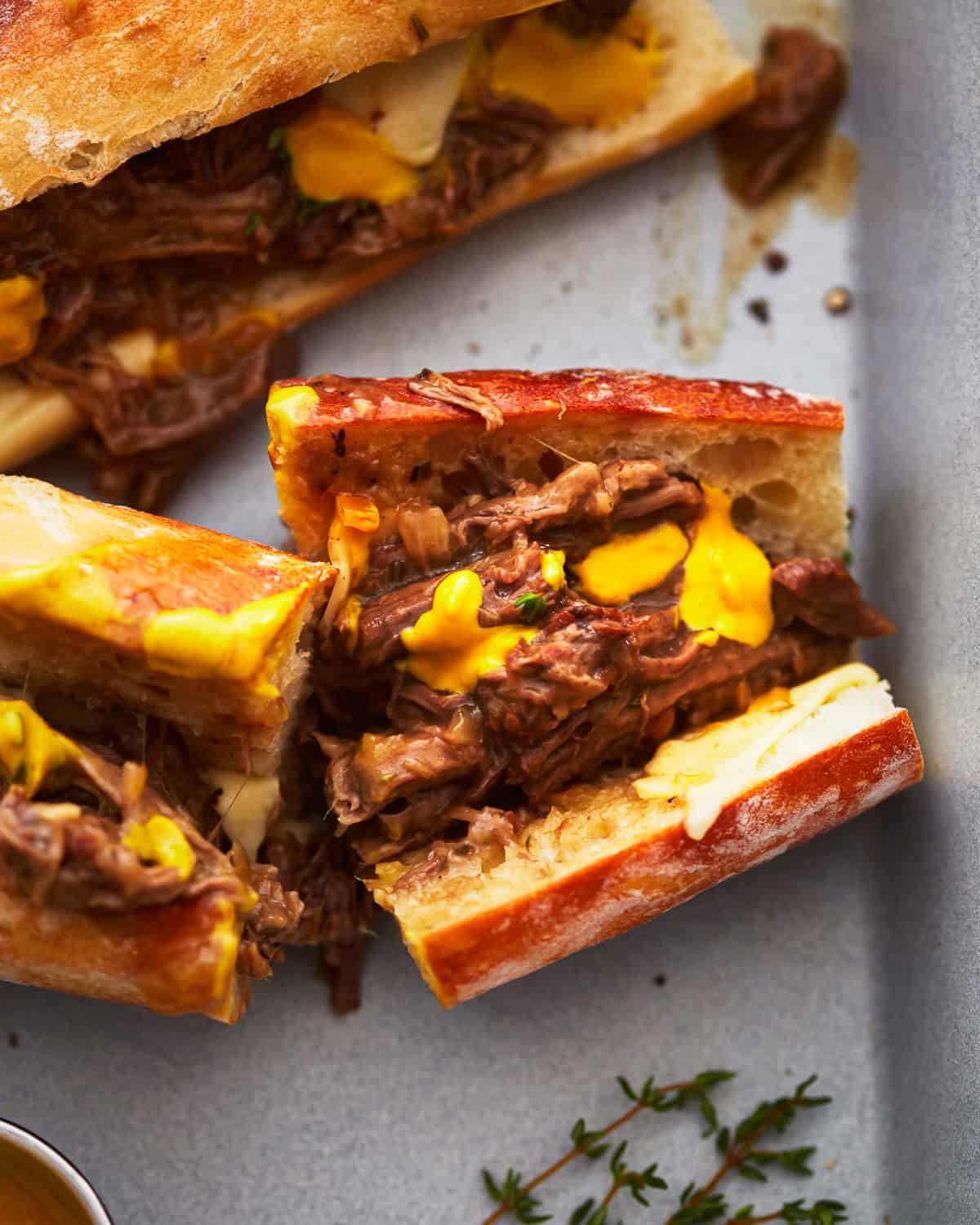 toasted hot beef sandwiches on split rolls with cheese.