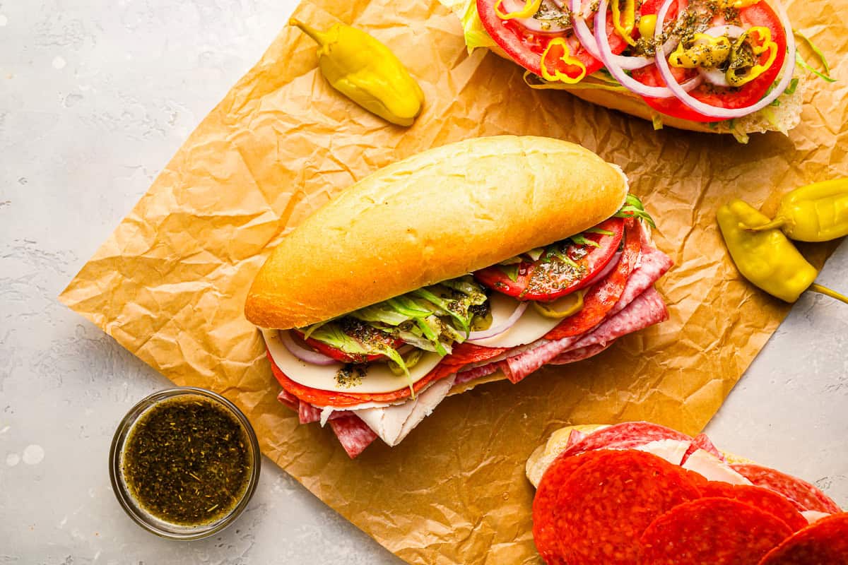 italian sub sandwiches on parchment paper.