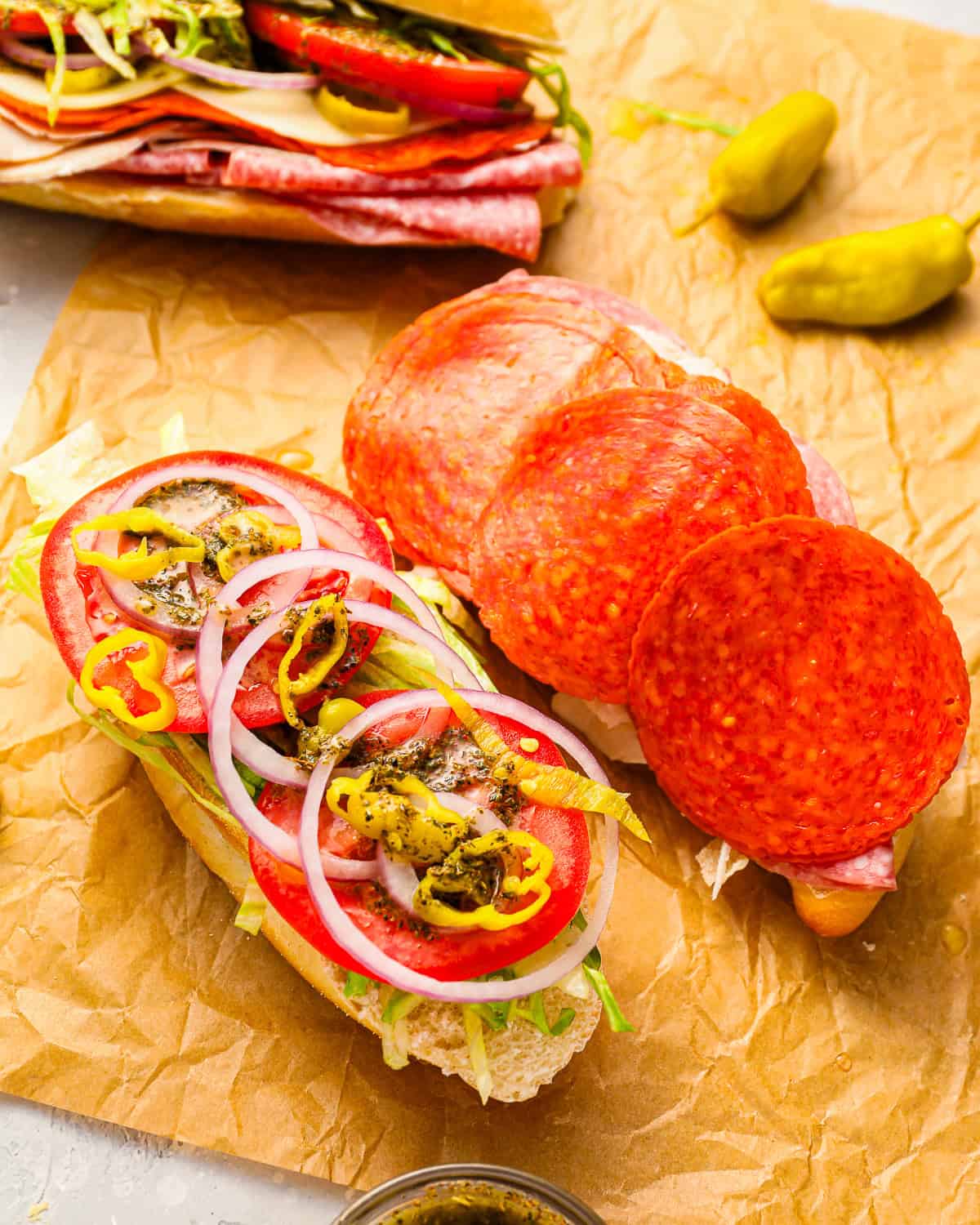 an open italian sub on parchment paper.