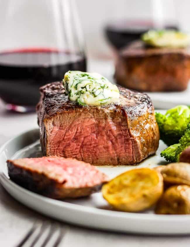 sliced steak with cilantro steak butter on top