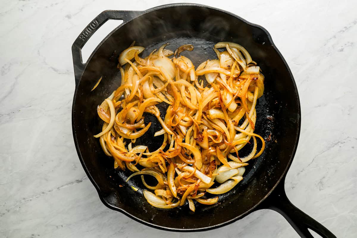 caramelizing onions in a pan.