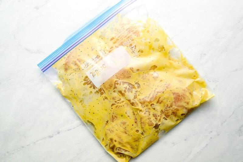 raw chicken breasts in a Ziplock bag with honey mustard marinade.