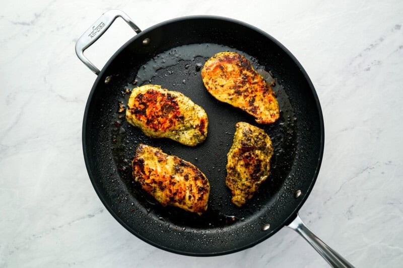 cooked chicken breasts in a skillet.