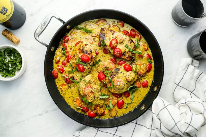 pesto chicken in a skillet.