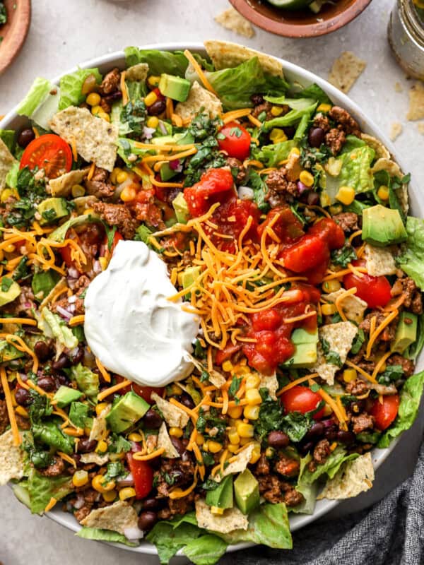 overhead view of taco salad in a bowl with sour cream.