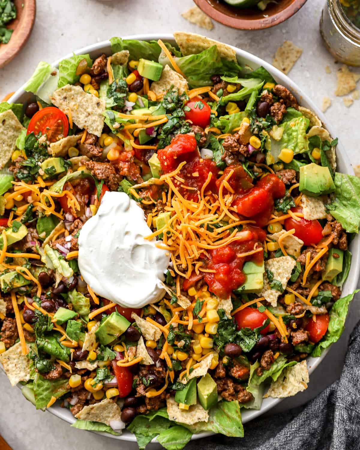 overhead view of taco salad in a bowl with sour cream.
