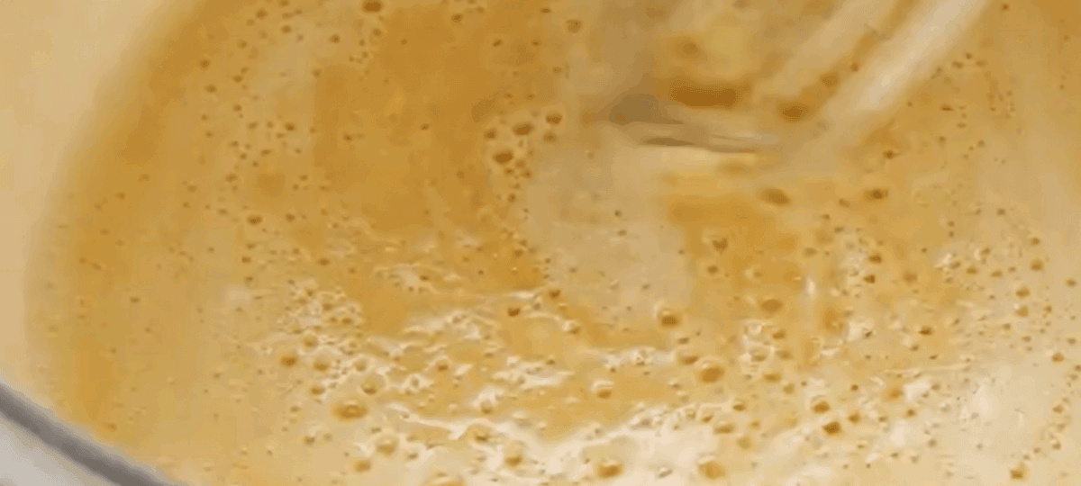 Combining milk and butter to make the sauce. 