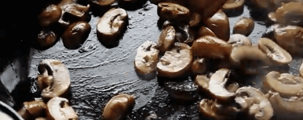Cooking mushrooms in a skillet.
