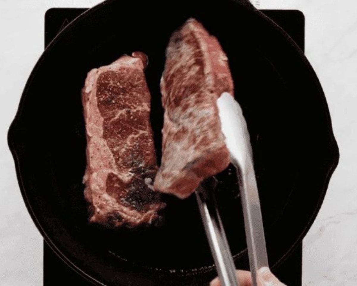 Flipping the steaks in the pan. - 11