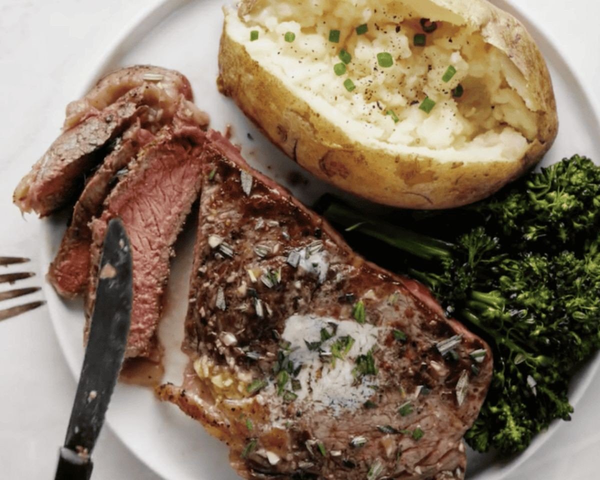 Steak with potatoes and broccoli on a white plate. - 13