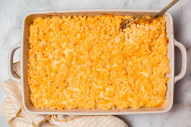 overhead view of chick fil a mac and cheese in a casserole dish with a spoon.