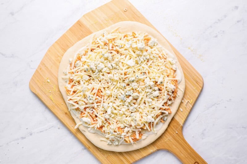 buffalo chicken pizza on a pizza peel.