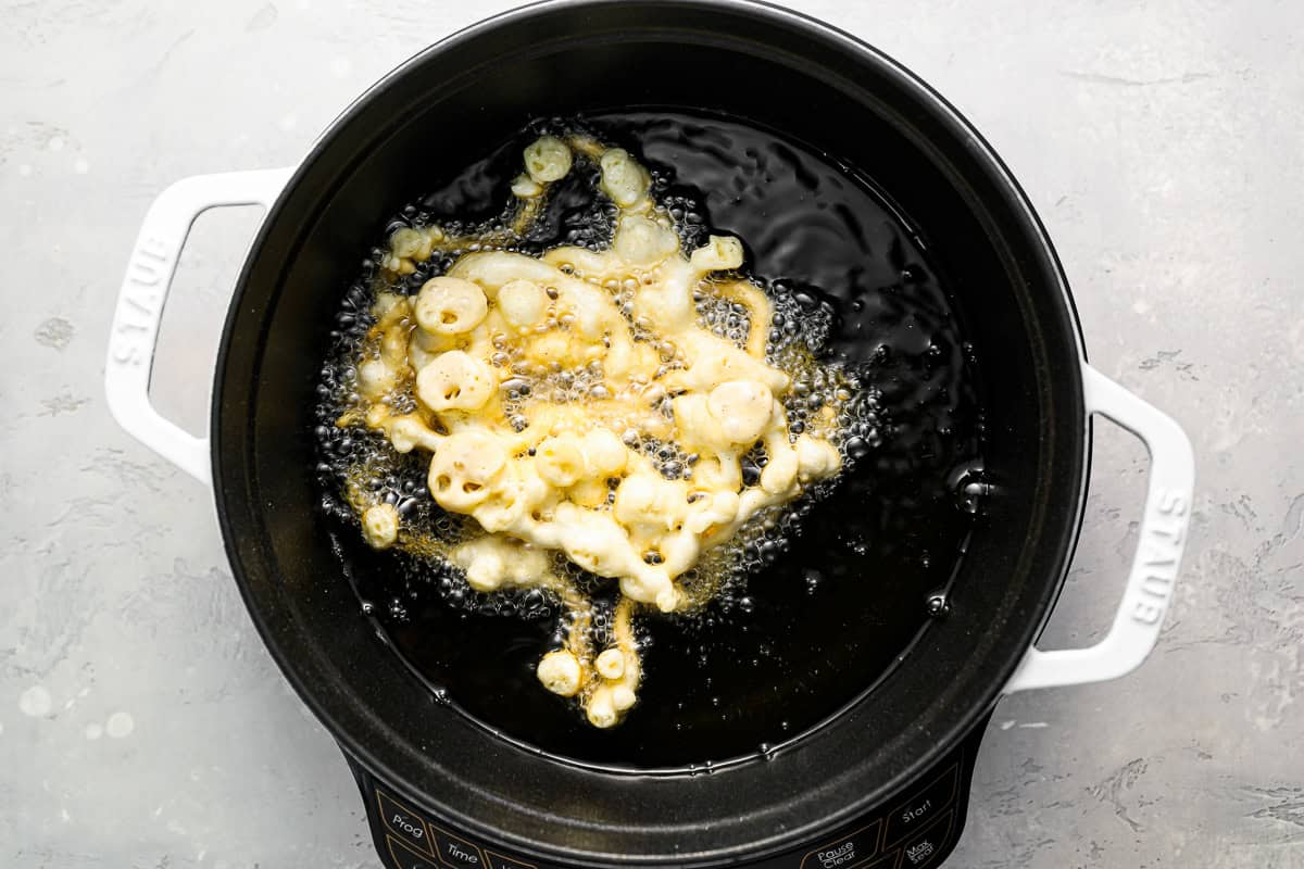 frying a funnel cake in hot oil.