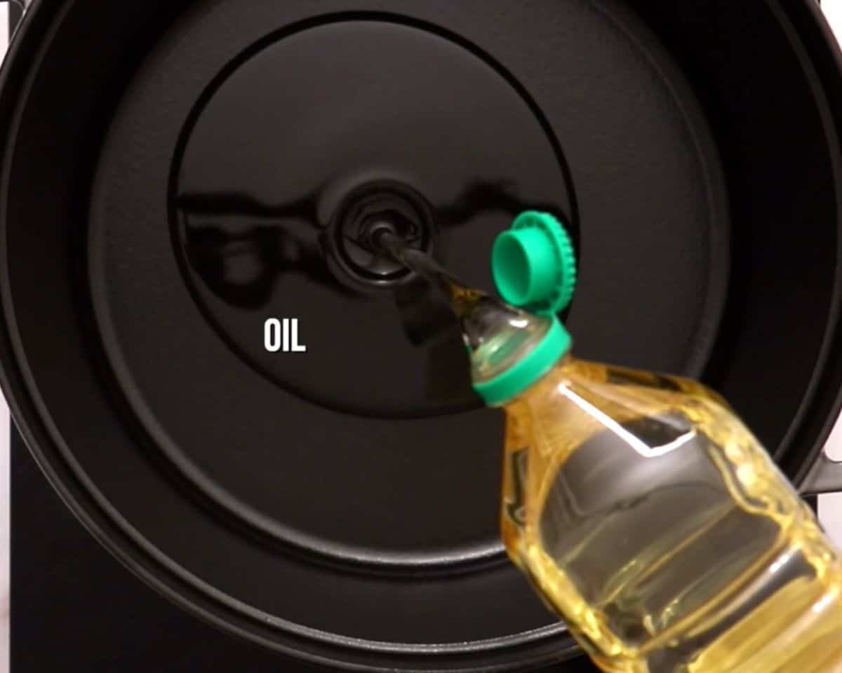 Pouring oil into the pan.