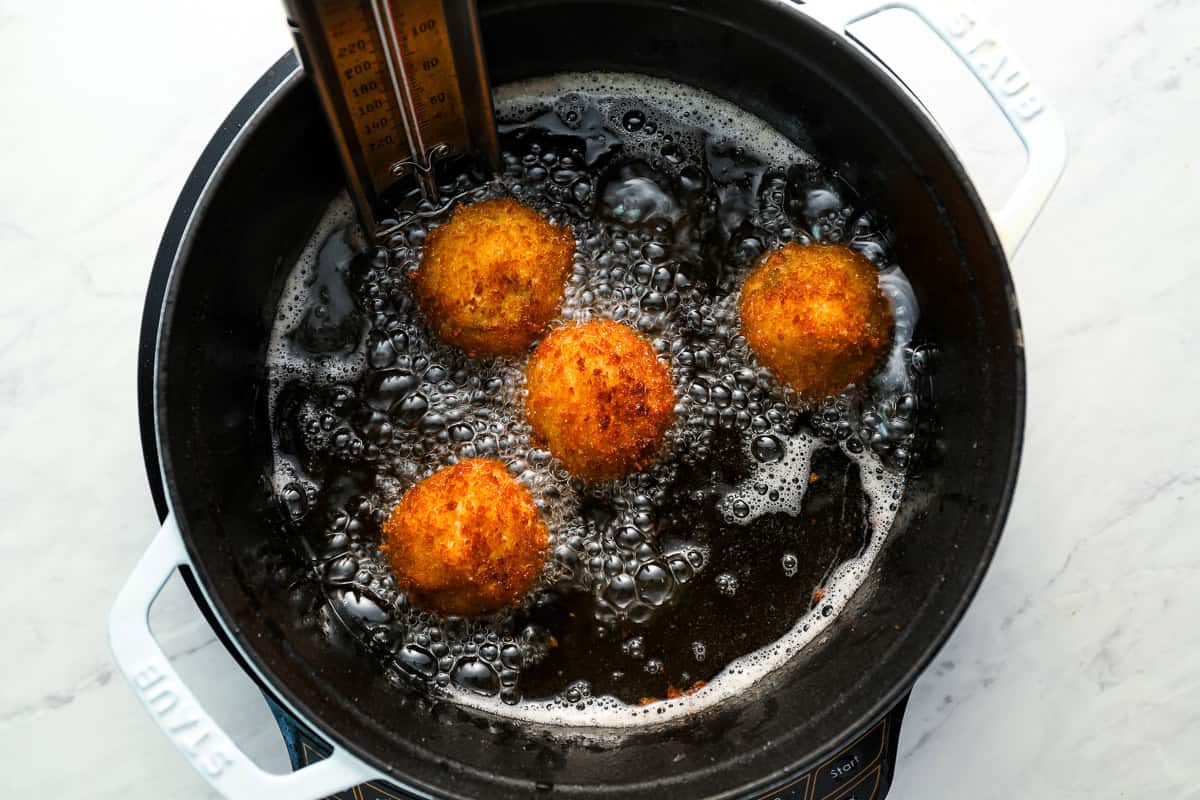 frying arancini in a dutch oven.