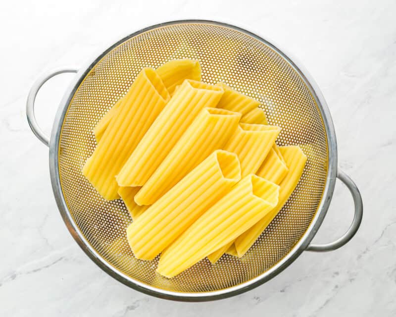 cooked manicotti noodles in colander