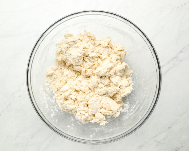 crumbly dough in a glass bowl.
