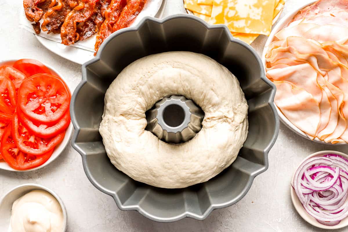 A Bundt pan filled with raw bread dough