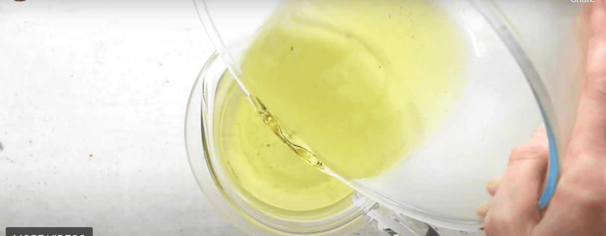pouring simple syrup into a pitcher.