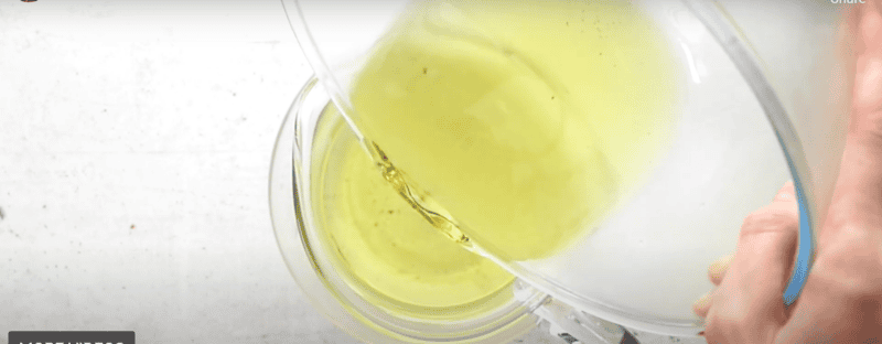 pouring simple syrup into a pitcher.