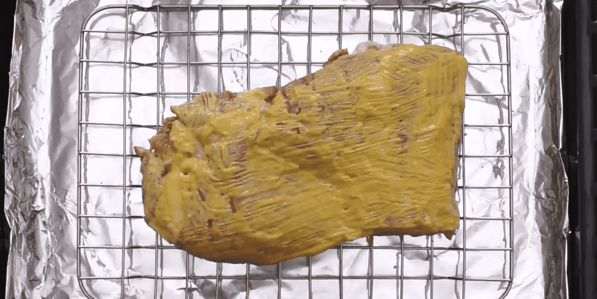 ribs coated with mustard and liquid smoke.