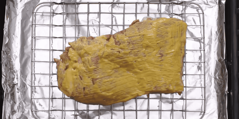 ribs coated with mustard and liquid smoke.