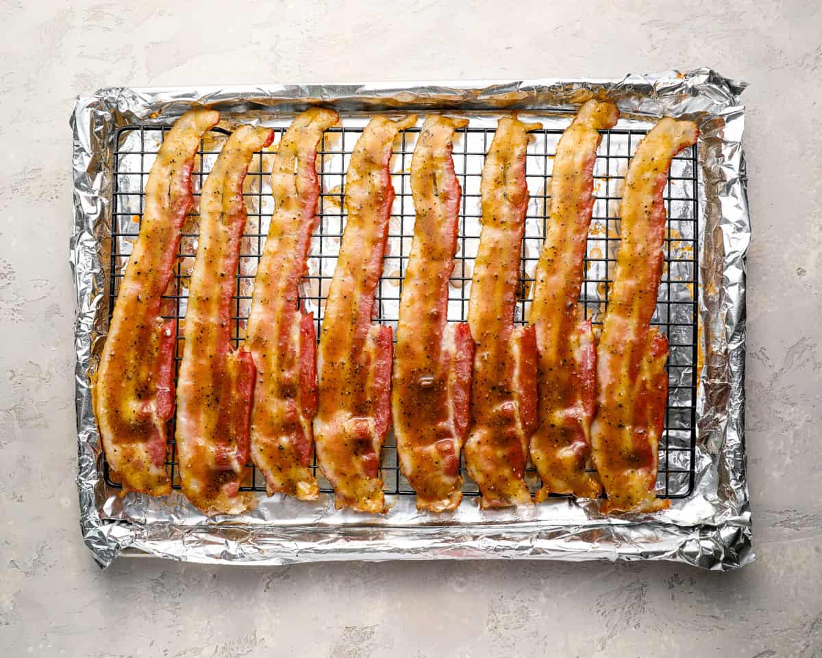 Partially cooked bacon coated with the glaze and ready to go back in the oven.