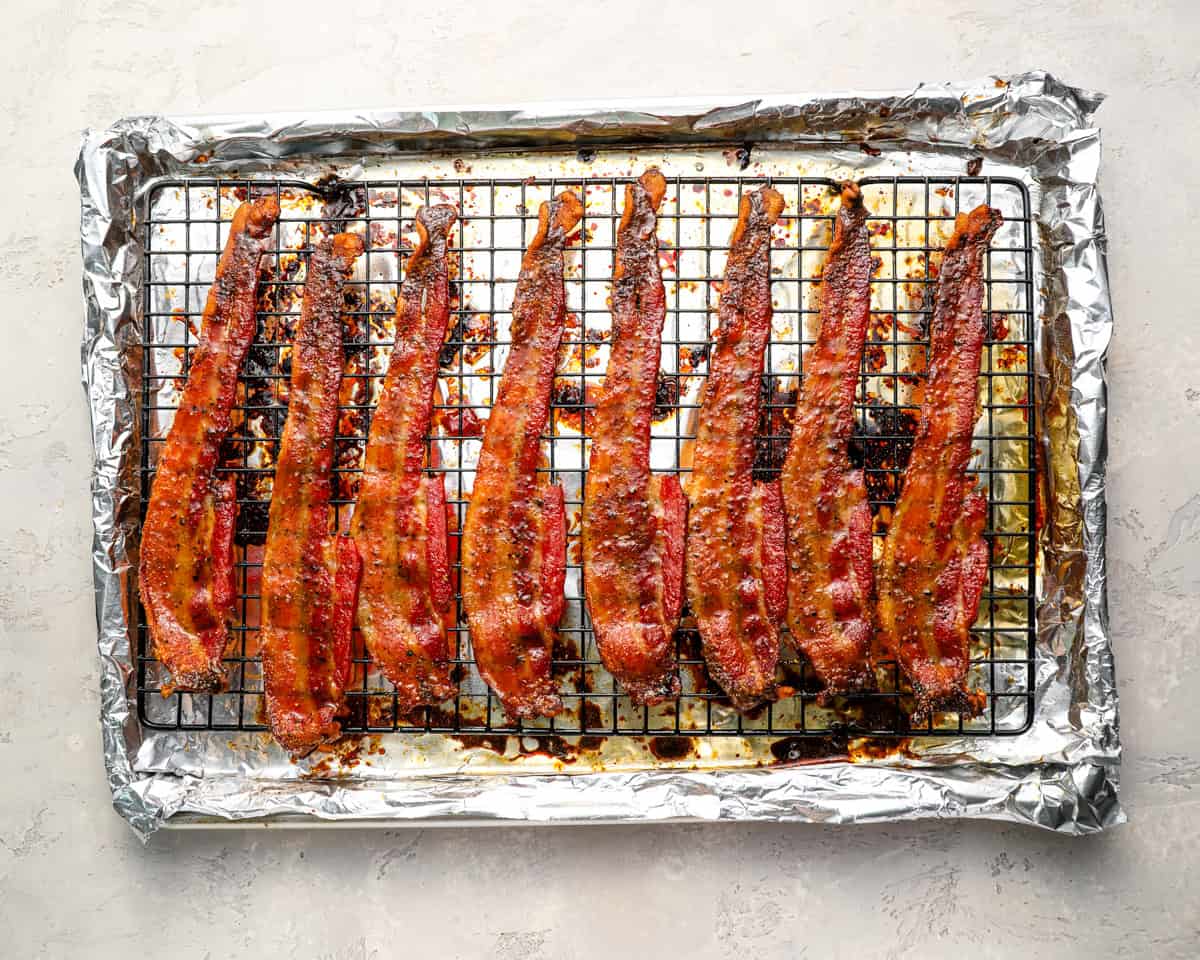 Fully baked candied bacon on the wire rack, caramelized and crispy.