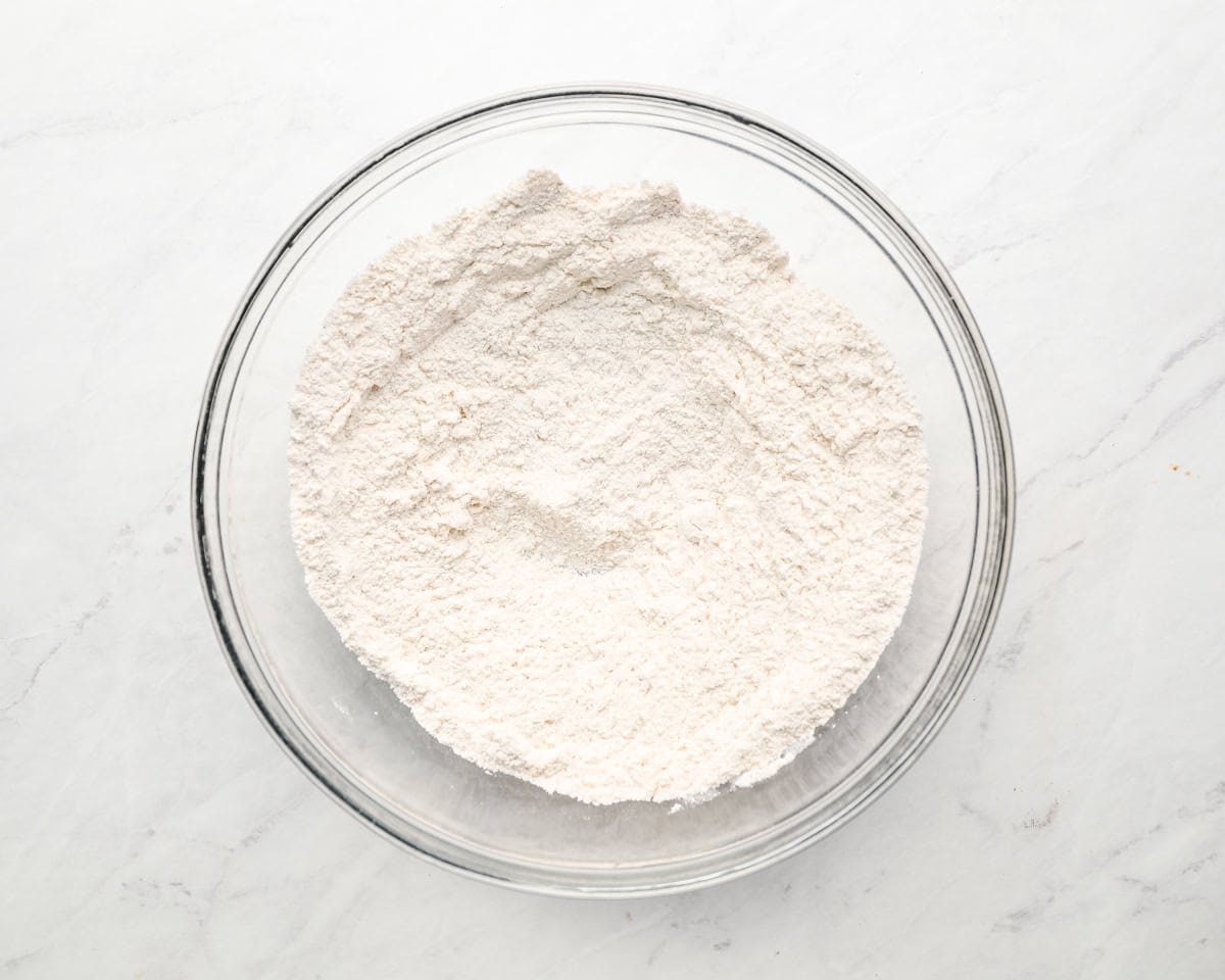 Dry ingredients mixed in a clear glass mixing bowl.