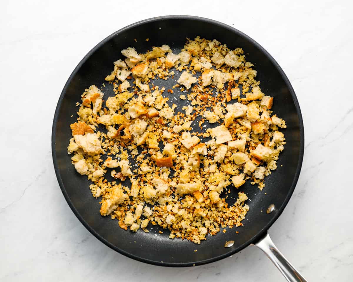 Golden, crispy homemade breadcrumbs in a skillet after toasting with olive oil.