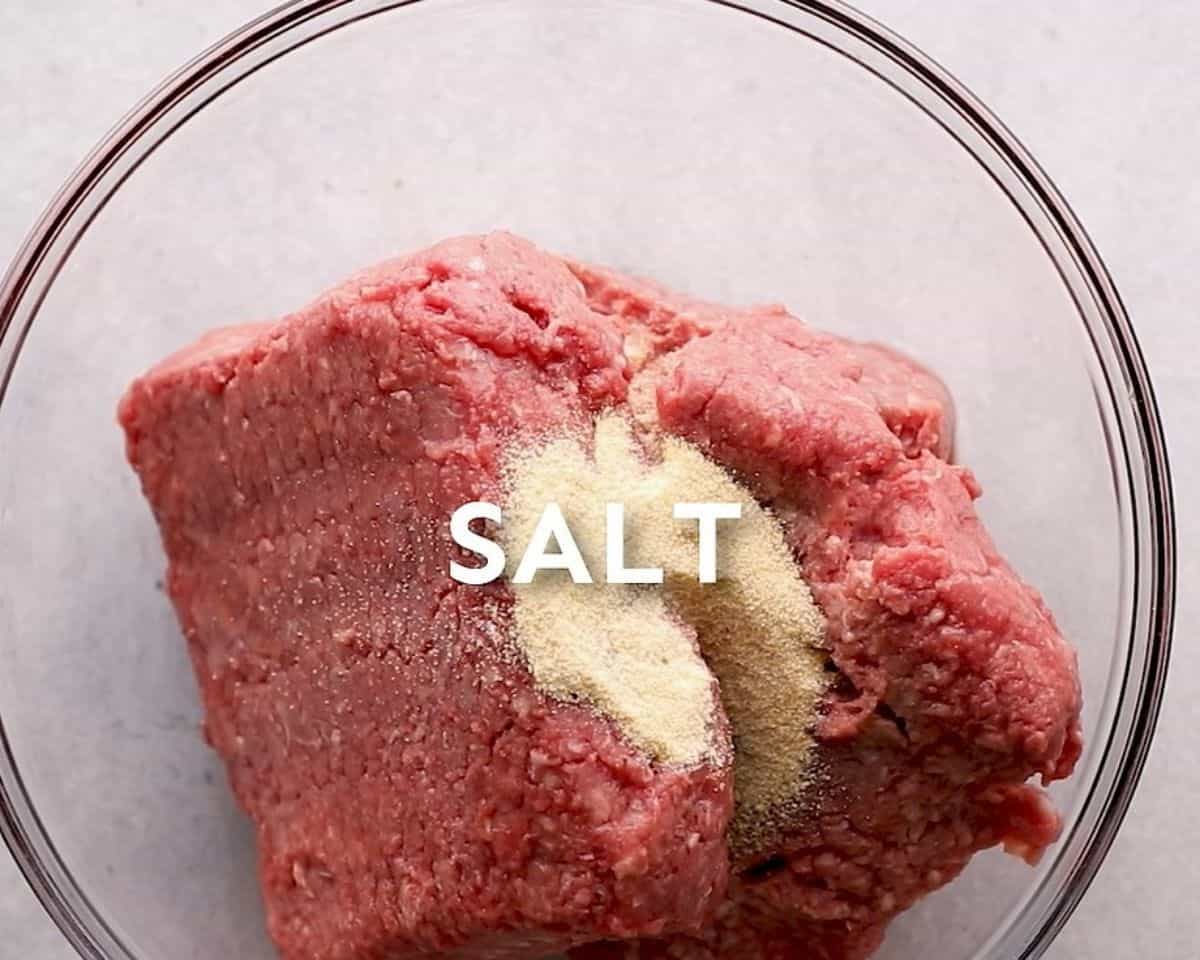 Preparing the ground beef with seasonings. 
