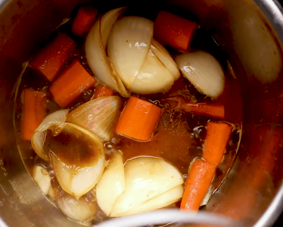 Broth added to the sautéed onions and carrots in the Instant Pot to deglaze the pan.