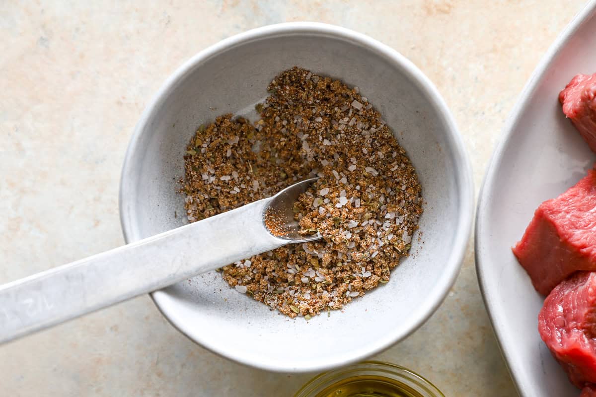 Bowl of homemade steak seasoning mix with salt, paprika, and spices, ready to use for air fryer steak bites.