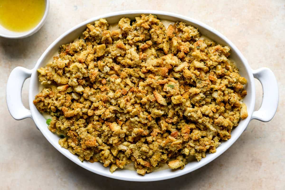 Prepared stuffing spread evenly over the casserole filling before baking.