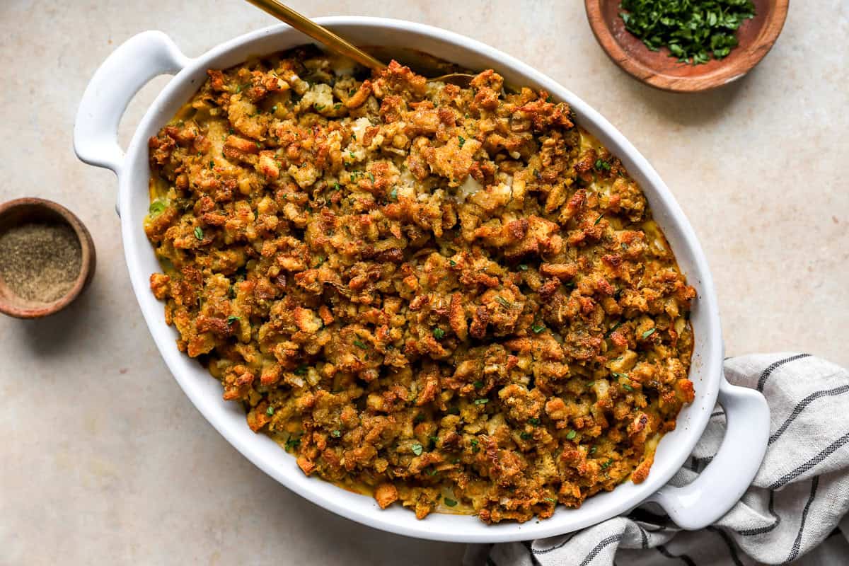 Golden-brown chicken stuffing casserole fresh from the oven in a white baking dish, topped with crisp, buttery stuffing crumbs.