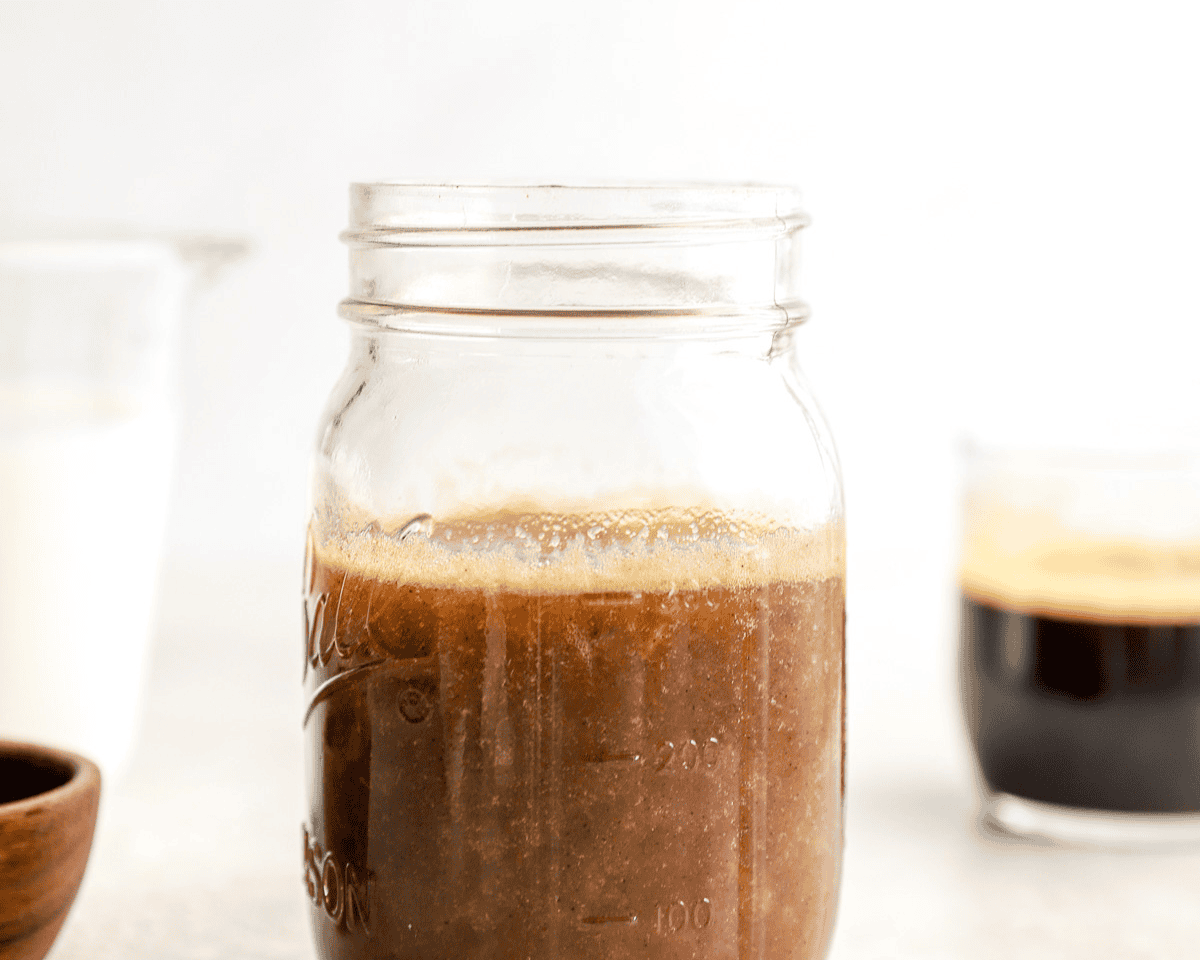 Finished homemade banana syrup cooling in a glass jar
