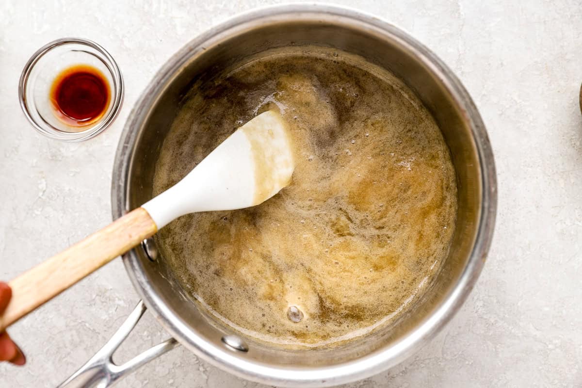 Banana syrup cooking on the stovetop until bubbly and slightly thickened