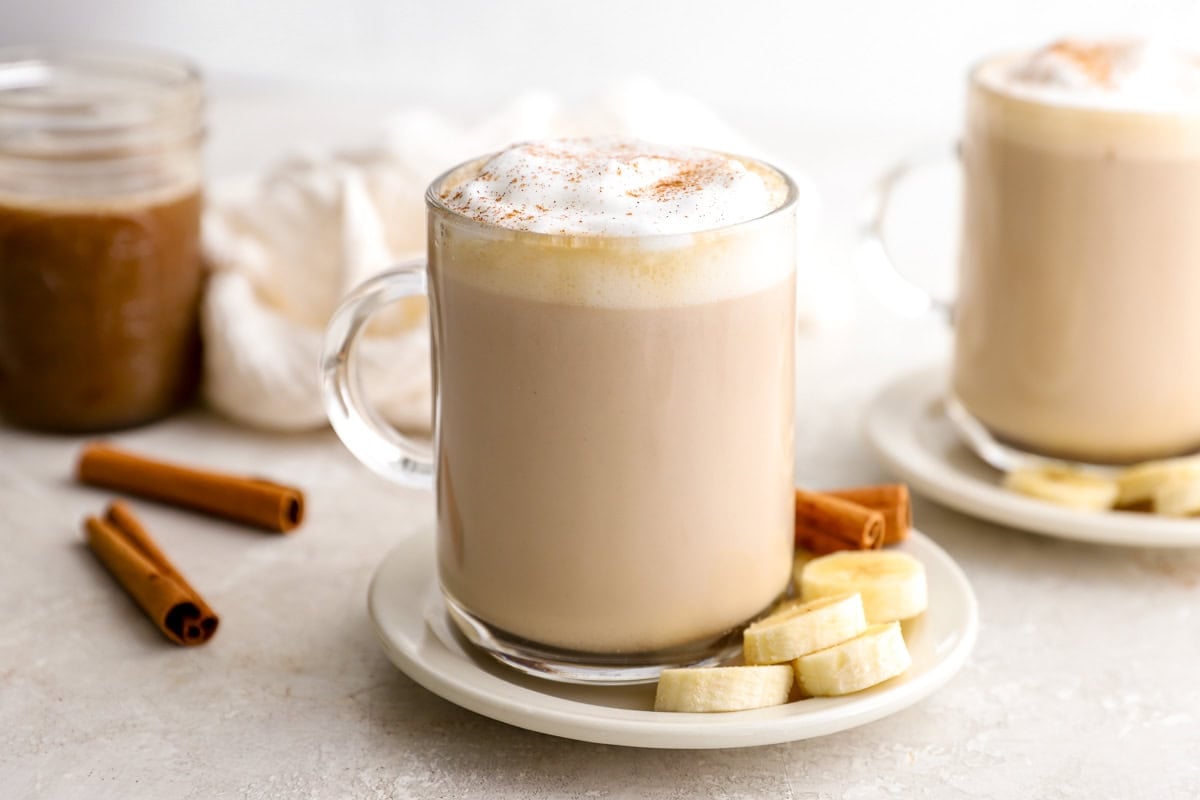 Homemade banana bread latte with foamed milk and cinnamon garnish on top