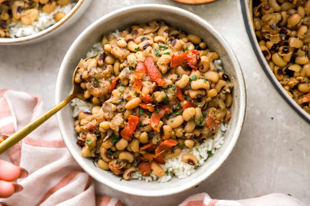 finished bowl of black eyed peas with spoon serving a bite