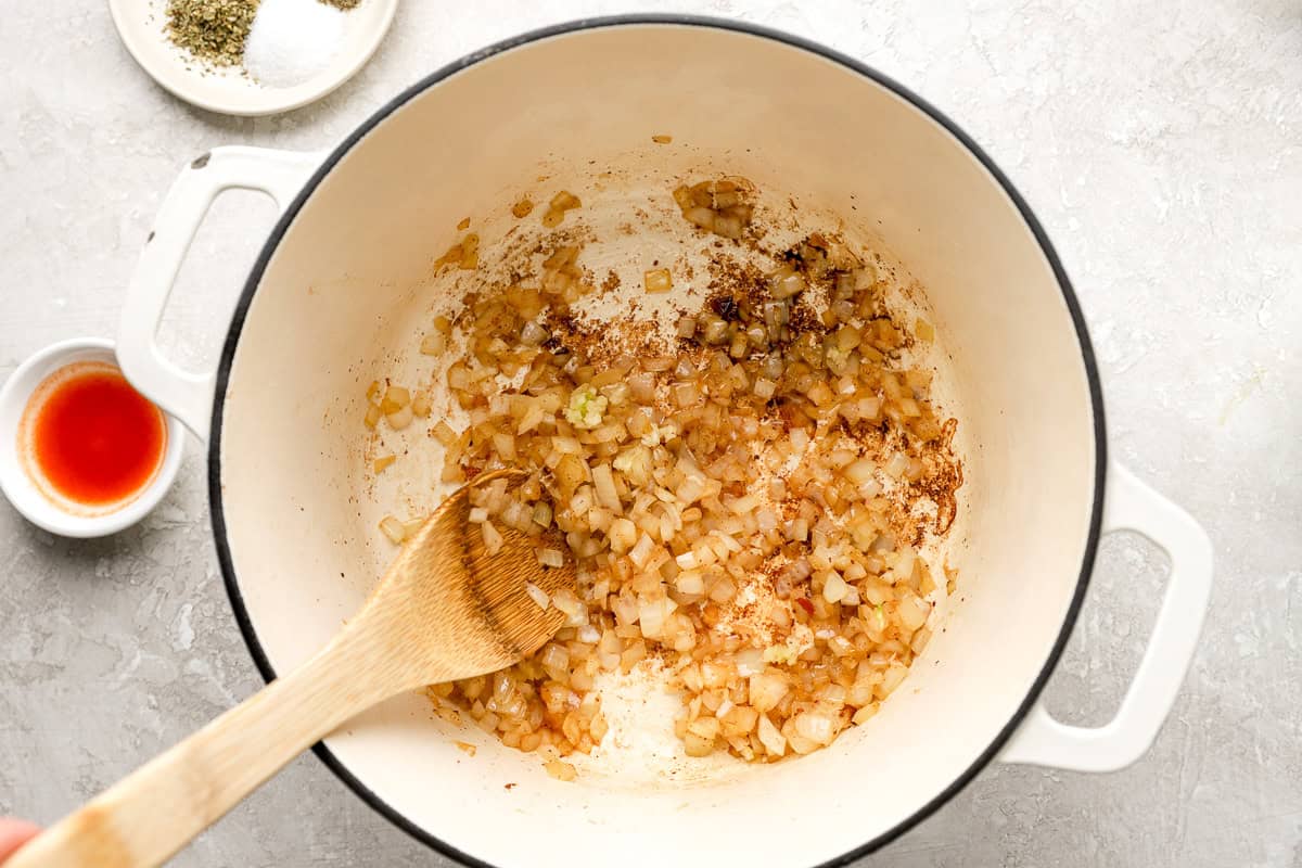 stirring onions and bacon fat together for black eyed peas