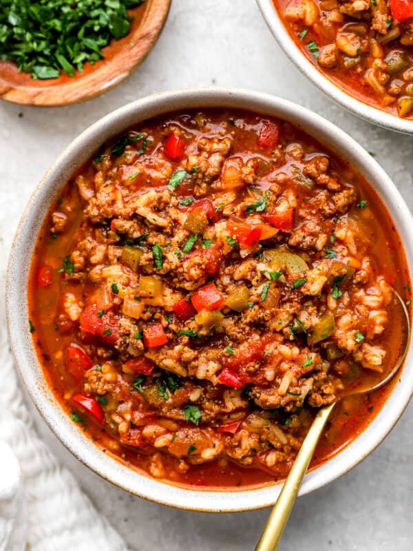 Bowl of crockpot stuffed pepper soup with ground beef, rice, bell peppers, and fresh parsley