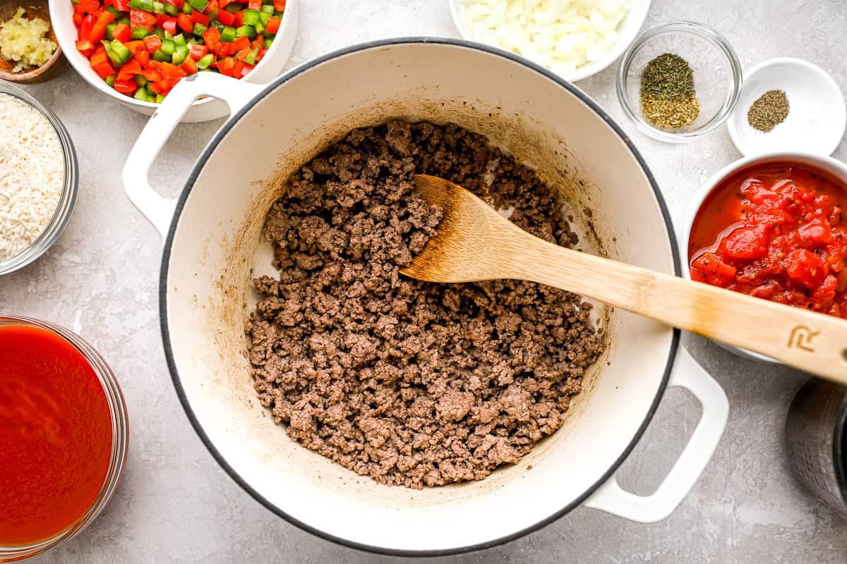 Ground beef browning in a pot for stuffed pepper soup