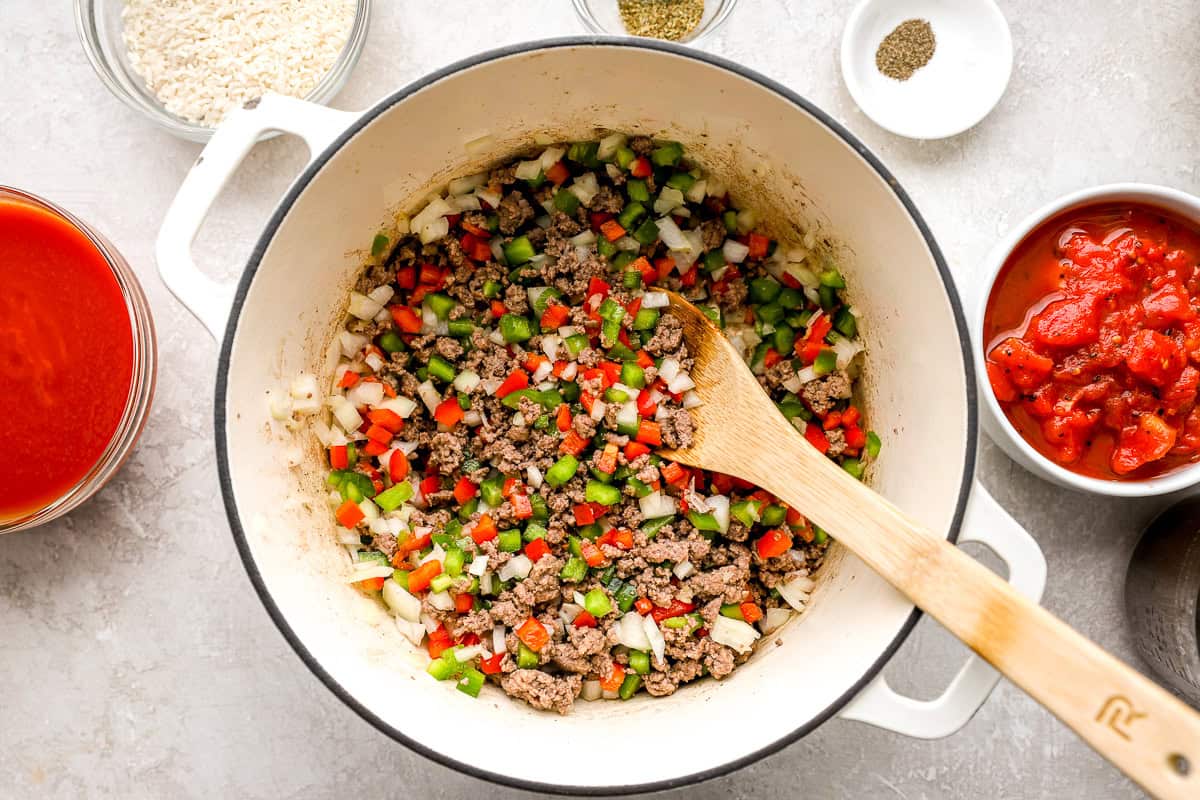 Chopped bell peppers and onions added to browned ground beef