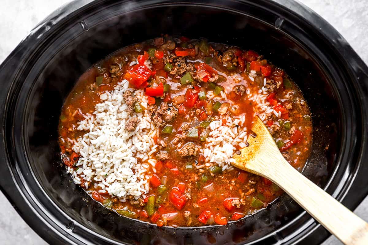 Cooked rice stirred into crockpot stuffed pepper soup