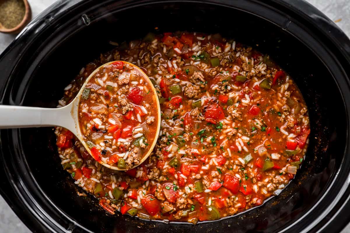 Ladle serving crockpot stuffed pepper soup from the slow cooker