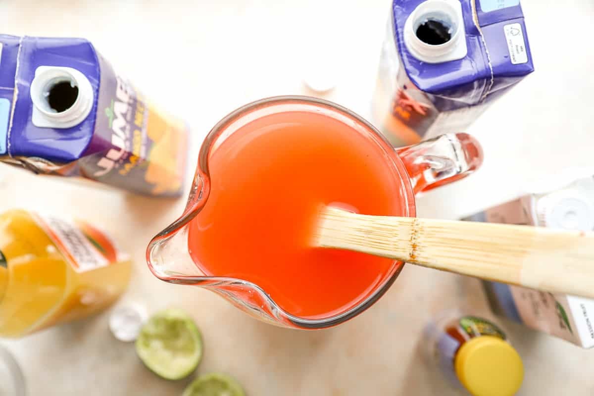 overhead view of pitcher of fruit punch with the juice bottles nearby