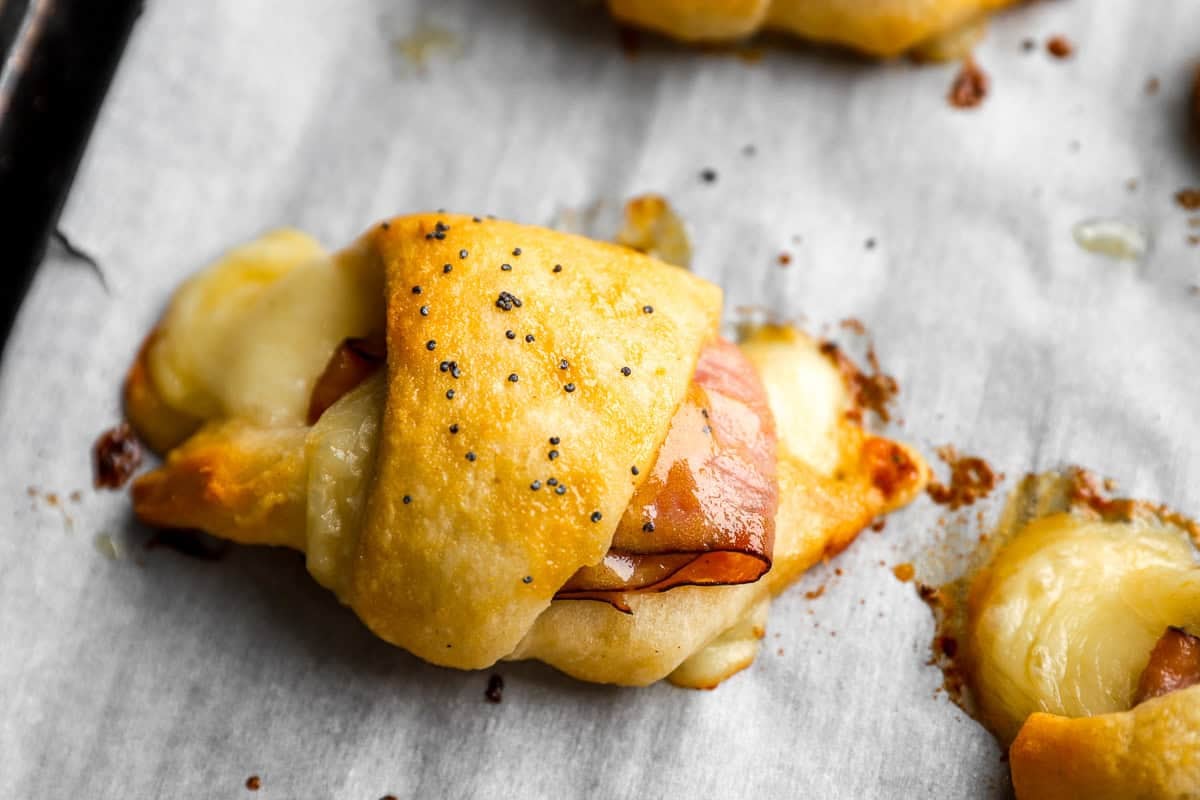 ham and cheese croissants baked on a baking sheet